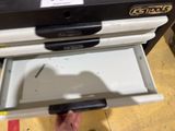 a person that is opening a drawer in a stove