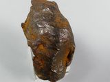 a close up of a piece of rock on a white surface