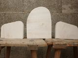 three pieces of wood sitting on top of a wooden bench