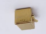 a gold lighter that is sitting on a white surface