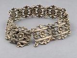 a close up of a silver bracelet with flowers on it