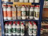 many bottles of milk on the shelf in the store
