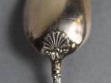a silver spoon with a silver handle on a table