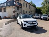a white car parked in front of a building