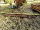 a large piece of machinery that is laying in the grass