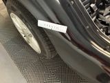 a close up of a car ' s front bumper with a sticker on it