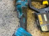 two electric tools that are laying on the floor