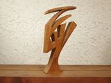 a wooden sculpture of a bird on a table