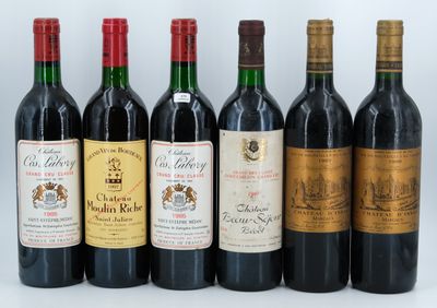 six bottles of wine are lined up in a row on a white surface