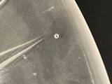 a black and white photo of a knife with a hole in it