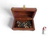 a small wooden box with a bunch of jewelry inside of it