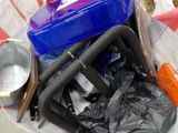 a plastic container with a blue lid and a black handle