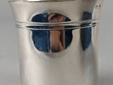 a silver cup that has a handle on it
