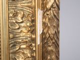 a close up of a gold frame with a bird on it