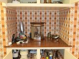 a small kitchen with a wooden counter and shelves