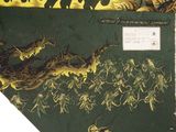 a picture of a green and yellow scarf with a picture of animals on it