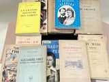 several books are stacked on top of each other on a table