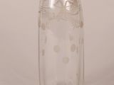 an old fashioned glass bottle with a gold lid and a metal stopper