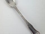 a spoon that is sitting on a white table