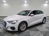 a white audi car parked in a large room with a checkered floor