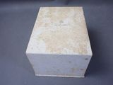 an old white box sitting on top of a blue table