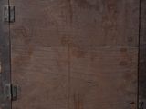 a brown wooden door with metal latches on it