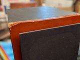 a black speaker sitting on top of a wooden table