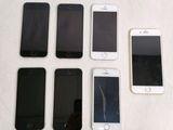 several cell phones are lined up in a row on a table