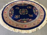 rug on the floor in a room with a chair and a table