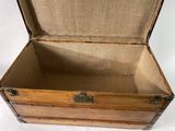a small wooden box with a metal latch on it