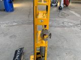 a close up of a yellow hand truck with a sign on the side of it