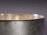 a metal bowl that is sitting on a table
