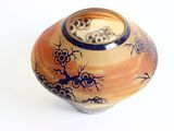 a vase with a design on it on a white surface