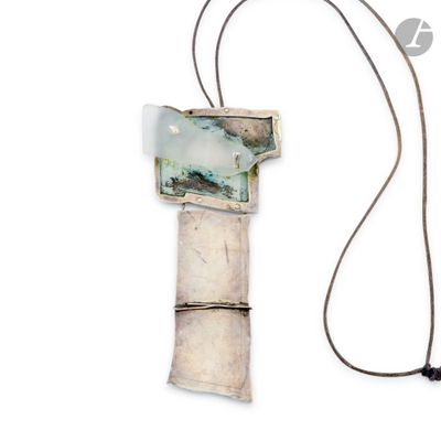 a necklace that has a picture on it on a cord