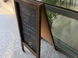 a sign that says menu outside of a restaurant