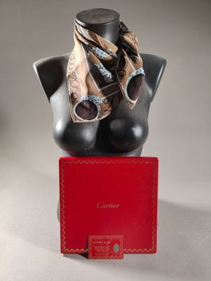 a black mannequin with a gold scarf on top of it