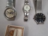 a lot of watches that are sitting on a table