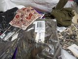 a pile of clothes and other items on a bed