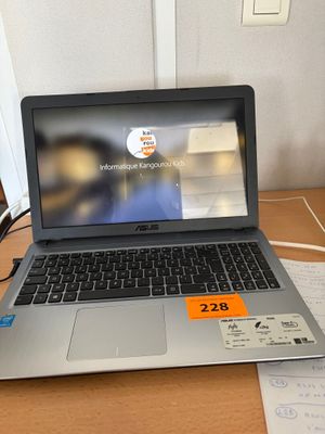 a laptop computer sitting on a desk with a price tag on it