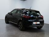the rear end of a black car parked in a garage