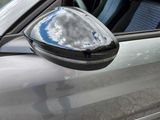 a reflection of a cloud in the side mirror of a car