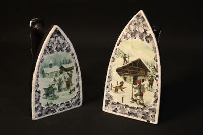 two decorative plates with pictures on them on a black background