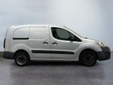 the white van is parked in a room with a gray floor