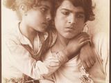 an old photo of a woman holding a child in her arms