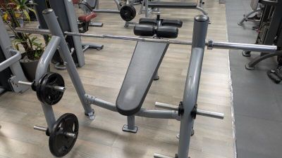 an image of a gym room with a bench and weights