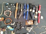 many different types of watches and bracelets laid out on a table