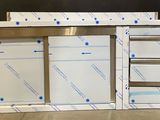 a picture of a kitchen cabinet with a lot of drawers