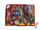 a red suitcase filled with assorted sewing supplies