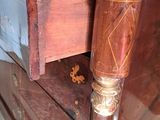 a close up of a wooden table with a drawer on it