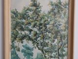 an oil painting of a tree in a frame on a table